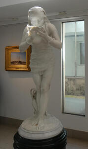 Sculpture of woman drinking from a shallow bowl