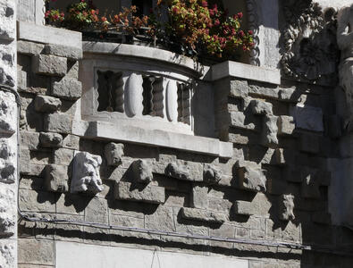 Wall under balcony, with stones protruding from the wall