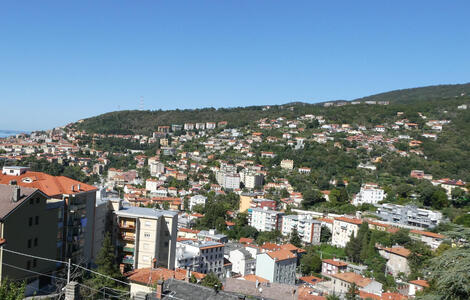 View of city buildings from a street high up in Trieste