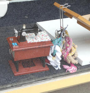 Toy sewing machine in store window