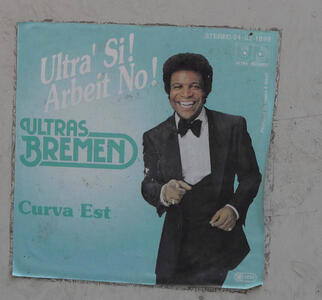 Phony album cover with a black performer in a tuxedo. Text reads: Ultra' Si! Arbeit No! Ultras Bremen Curva Est