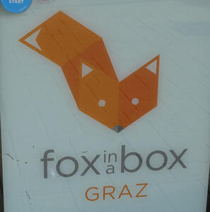 Logo with picture of fox make out of diamond-shaped elements. Text: fox in a box / GRAZ