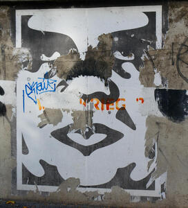 Partially torn-off Andre the Giant grafitti