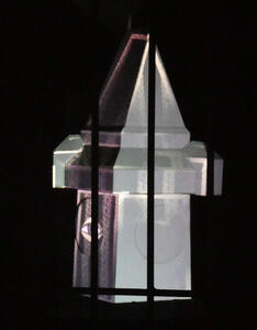 Small model of Uhrturm with images projected onto it.