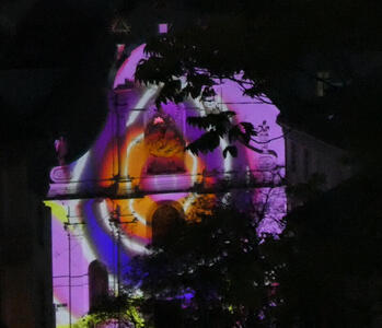 Circular multi-colored pattern projected onto church