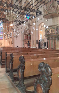 Church interior with diamond-shaped mirrors hanging from ceiling
