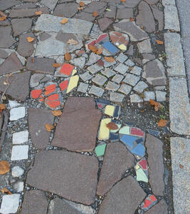 Colored mosaic pieces in sidewalk