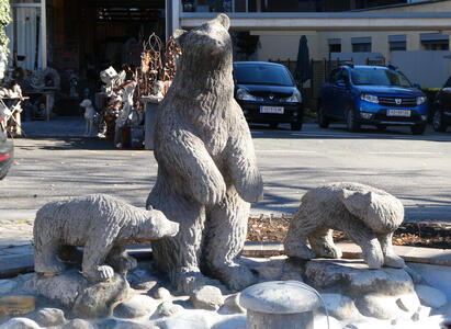 Sculpture of mother bear on hind legs with two cubs on all fours