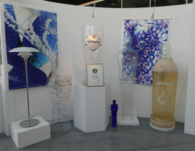 Very large beer glasses and bottle of Almdudler herbal soda