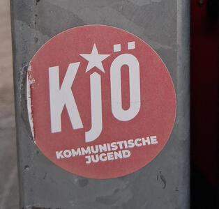 KjÖ / Kommunistische Jugend (text in white on red background. the J has a star above it.