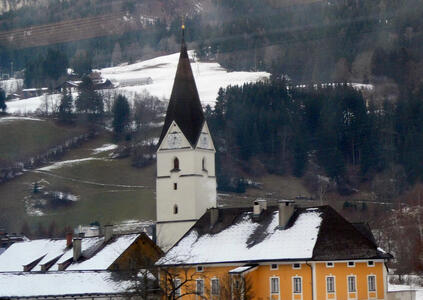 Church in background, yellow building in foreground