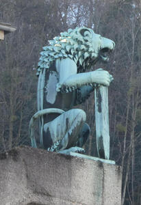 Bronze patina statue of lion on its haunches