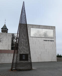 Modern art museum. In front, a conical metal latticework