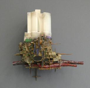 Fantastical building with insect-hive look at lower level, white columns at top level.