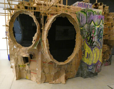Room built out of cardboard, with two large oval windows