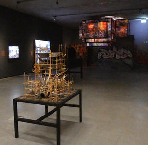 Building model in foreground; projected displays on ceiling in background