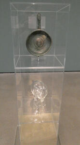 Frying pan with a seal showing something like a greek god’s head in the bottom of the pan.