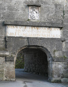 Stone archway; above it is a plaque dated 1635
