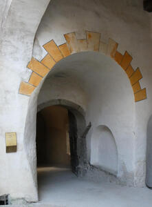 Arch with yellow-painted “stones” at top