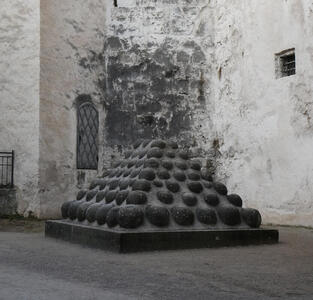 Pyramid of cannonballs embedded in concrete