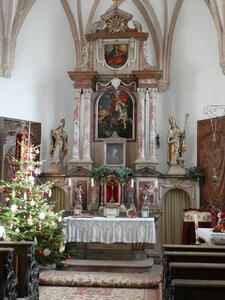 Interior of church on fortress grounds showing altar. Christmas tree at left.