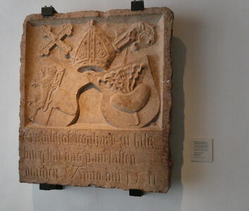 Plaque with shields beneath bishop’s miter, cross, and shepherd’s staff. Dated 1511