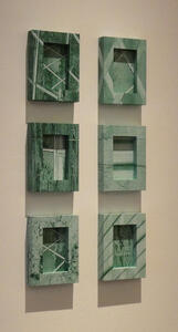Six rectangular panels in a two-column array; the panels are carved from a green stone.