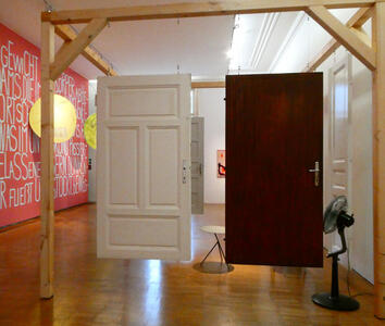White-painted and dark wood doors hanging from a wooden frame.