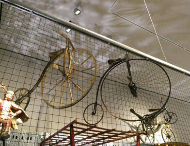 Two pennyfarthing bicycles suspended from ceiling
