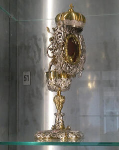 Gold goblet with “lid” that has a red gem and  gold crown on top