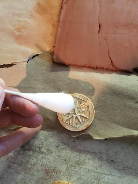 cotton swab applying oil to mold