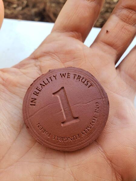 side with large number 1 and motto “In Reality We Trust”