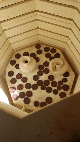 top view of tokens on shelf in kiln