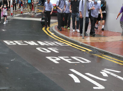 Painted traffic sign on street: BEWARE OF PED