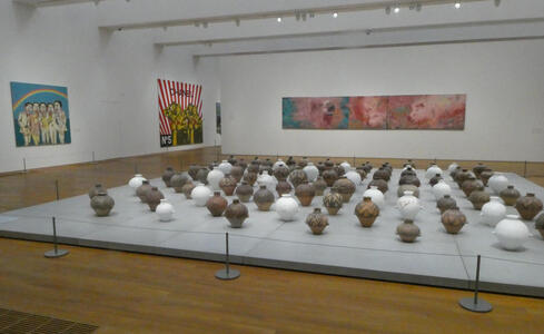 Array of clay pots, some of which have been painted white.