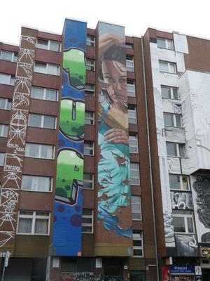 At left, fat green letters 1UP; at right, woman in turquoise dress