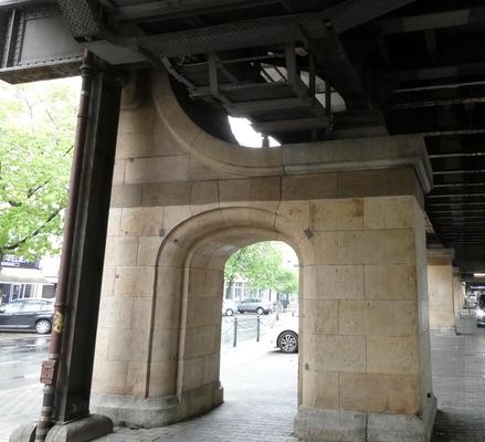 Brick support for bridge; support has an archway in it.