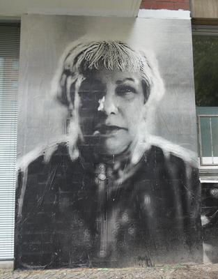 Large grayscale photo of woman with short hair