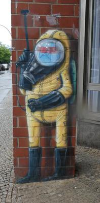 Blue-skinned indigenous person in a yellow pest exterminator uniform.