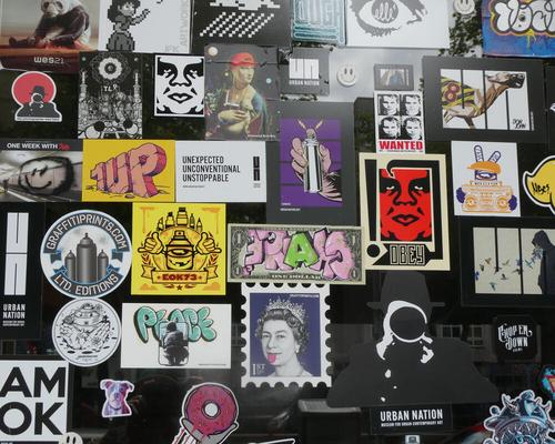 Large variety of stickers on a wall.