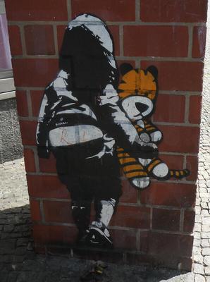 Black and white realistic drawing of child (back is to viewer) carrying a Hobbes stuffed toy (in color)