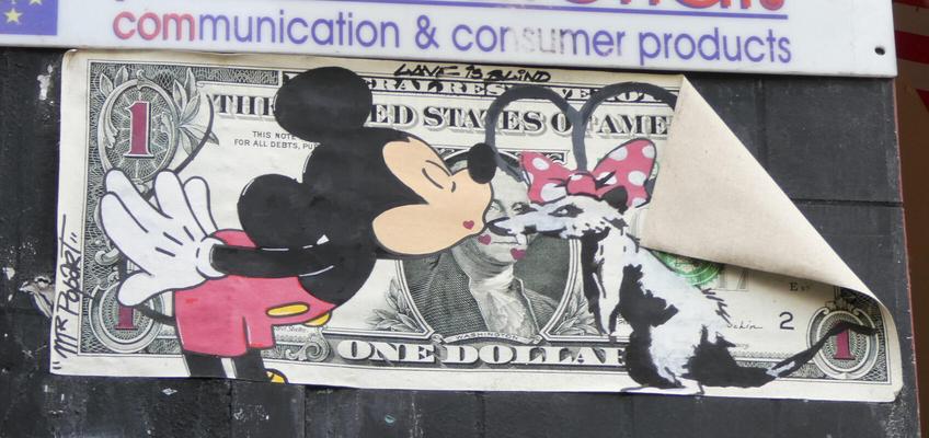 In foreground, Mickey Mouse kissing a rat with a Minnie Mouse hair-bowtie. In background, a USA one-dollar bill.