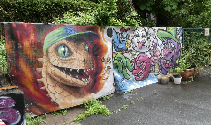 At left, snake wearing  green baseball cap. At right, cartoonish figures.