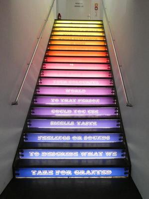 Rainbow-colored stairs with words on each step.