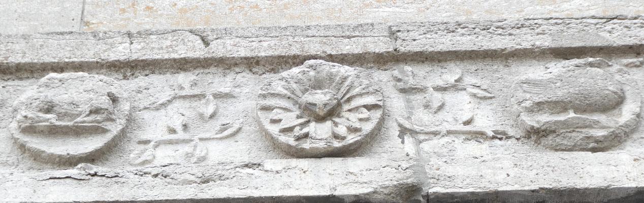Stone circles carved with flower motif, fish, and other animal