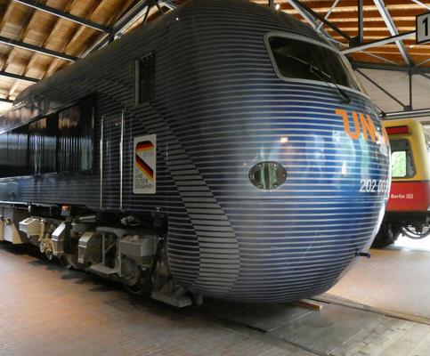 modern streamlined lead train car; blue with white horizontal stripes