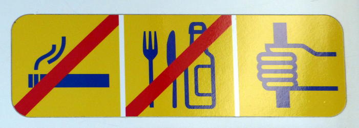 Sign in tram with symbols for no smoking, no food/drink, hold on to pole