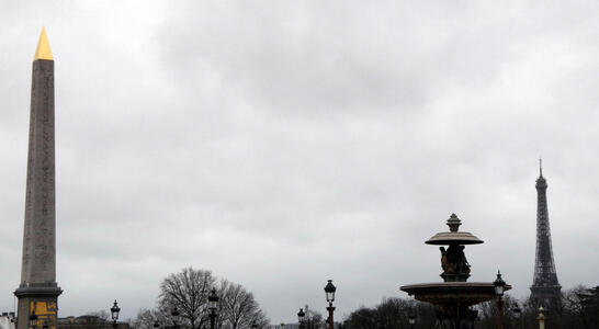 Obelisk with gold top at left; Eiffel Tower at right