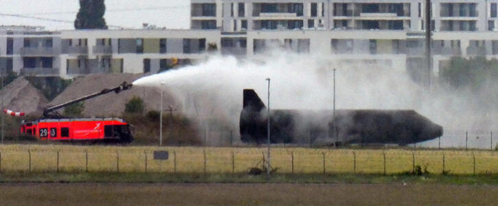 Fire truck spraying water over a plane.