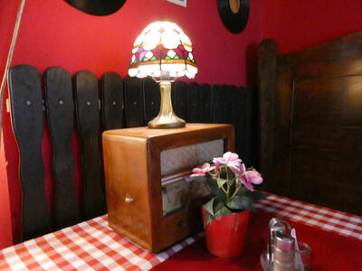 Small Tiffany-style lamp on old radio.